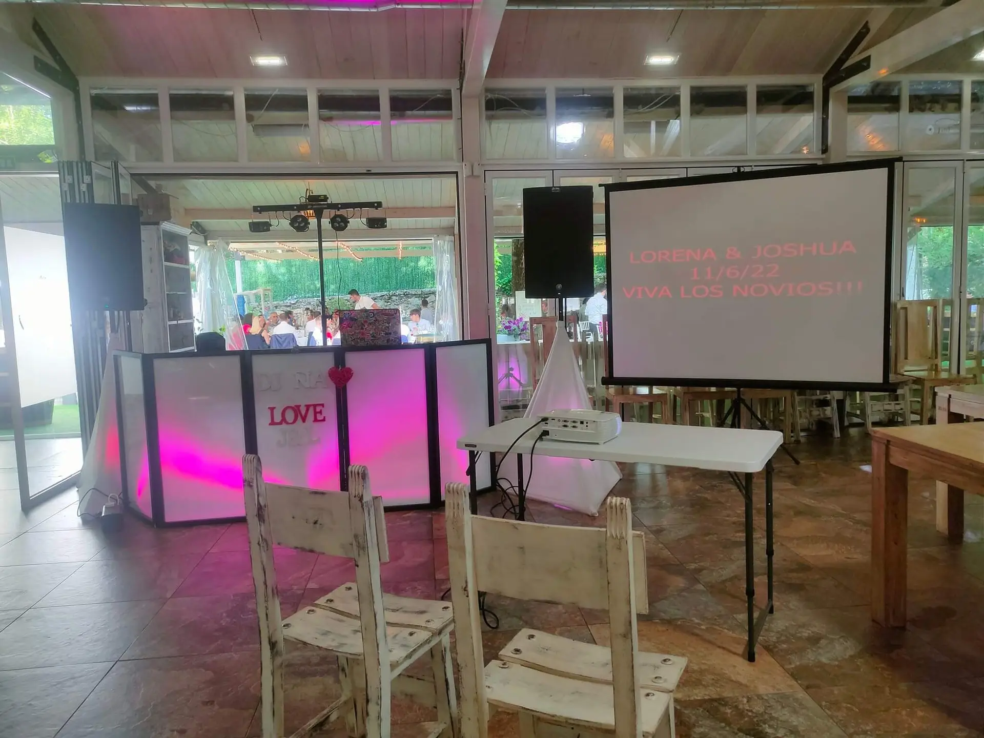 Imagen de montaje de cabina dj en bodas con pantalla de proyeccion a un lado